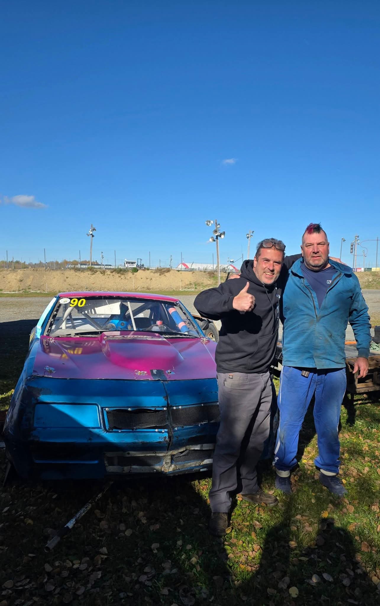 Team with the #90 car at the track